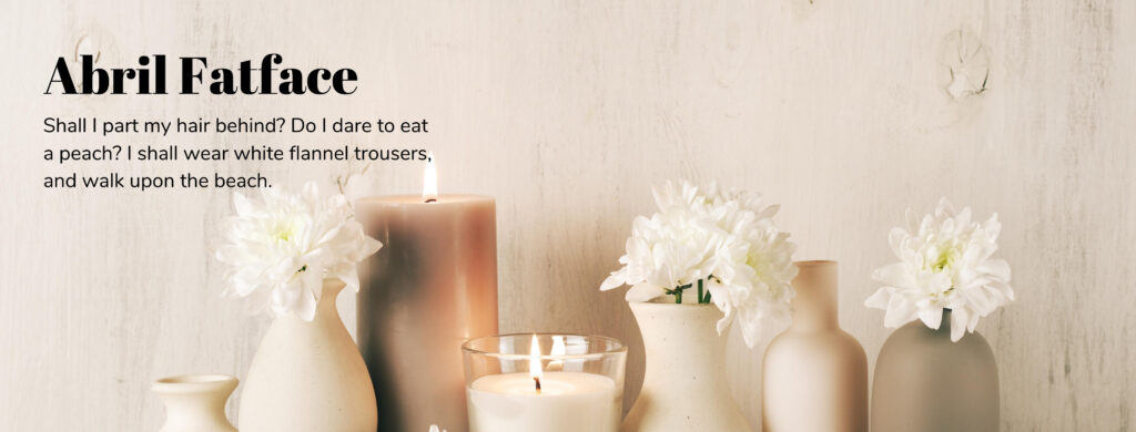Photo of candles lit with flowers - white and tan aesthetic